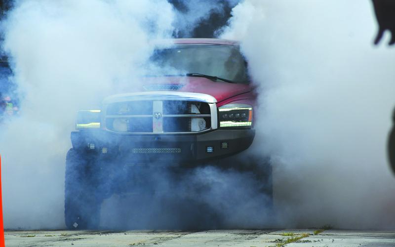 Enoch Autry/The Clayton Tribune. The Clayton Police Department hosted an event to get Christmas toys for underprivileged children and the Oct. 11 car show/burnout event was successful. Austin Shook’s Dodge Mega 3500 (above) was the first-ever burnout contest winner. See more on page A6.