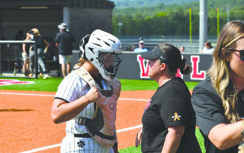 Wesley Branch/The Clayton Tribune. Rabun County softball sophomore River Evans (left) and head coach Jessica Evans (right) talk after the end of the top half of an inning versus Tallulah Falls School on Aug. 16. River is the daughter of coach Evans.