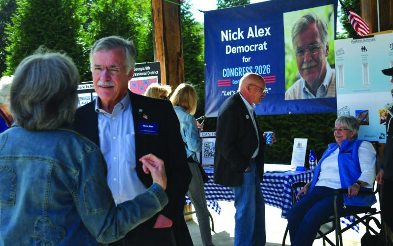 Enoch Autry/The Clayton Tribune. In the foreground, Rabun Countian Nick Alex has a conversation with individuals at the Democratic Party’s 9th Congressional District Blue BBQ in Cllayton on Oct. 11.