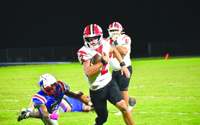 Wesley Branch/The Clayton Tribune. Rabun County quarterback Ty Truelove runs for positive yards versus Oglethorpe County on Oct. 10. Truelove threw for 193 yards and rushed for 82 more along with three total touchdowns for the Wildcats