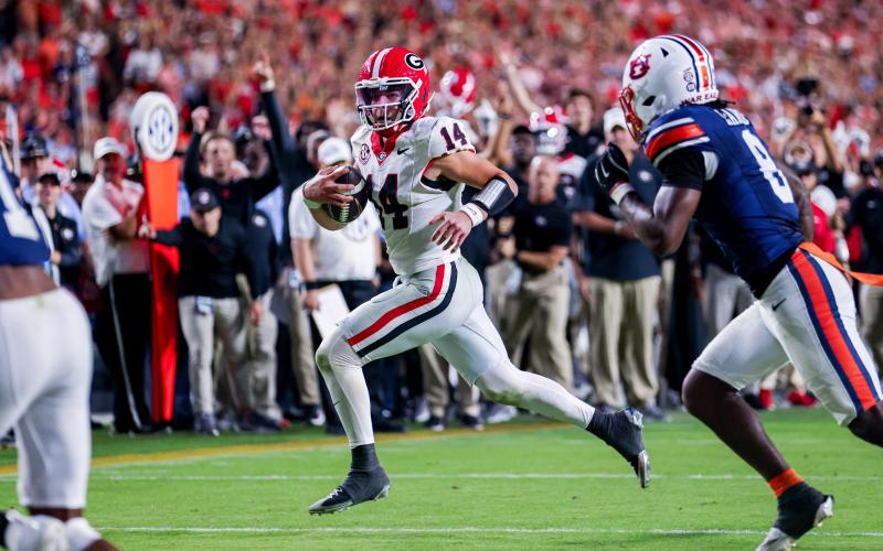 Conor Dillon/UGAAA. Current Georgia and former Rabun County quarterback Gunner Stockton runs versus Auburn in the Bulldogs’ 20-10 road win over the Tigers on Oct. 11. The win was the ninth-straight victory for Georgia over Auburn.