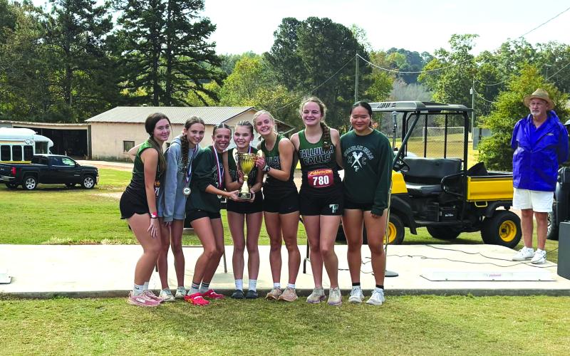 Submitted Photo. Tallulah Falls girls cross country members Olivia Henderson, Avery Keim, Naomi Russo, Mary Kate Ball, Eliza Culp, Meredith Orr and Emily Cai hold up their region championship trophy.