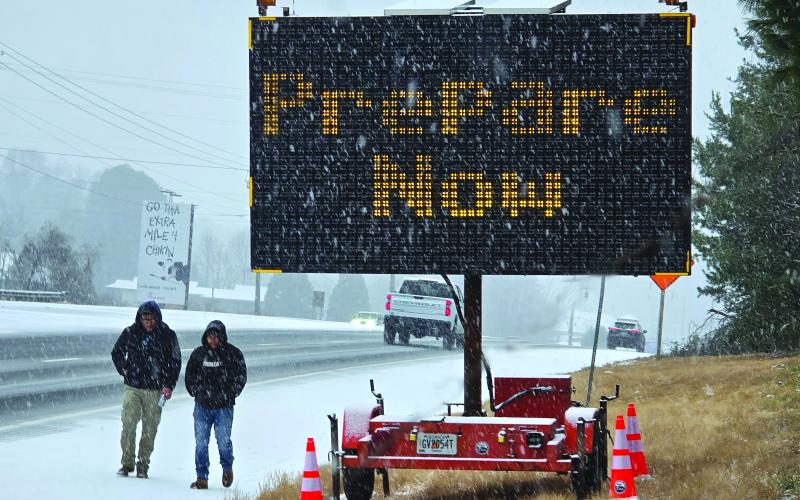 Enoch Autry/The Clayton Tribune. As pedestrians walk along U.S. Hwy. 441 in January 2025, motorists are warned about Winter Storm Cora’s arrival that blanketed Rabun County earlier this year.