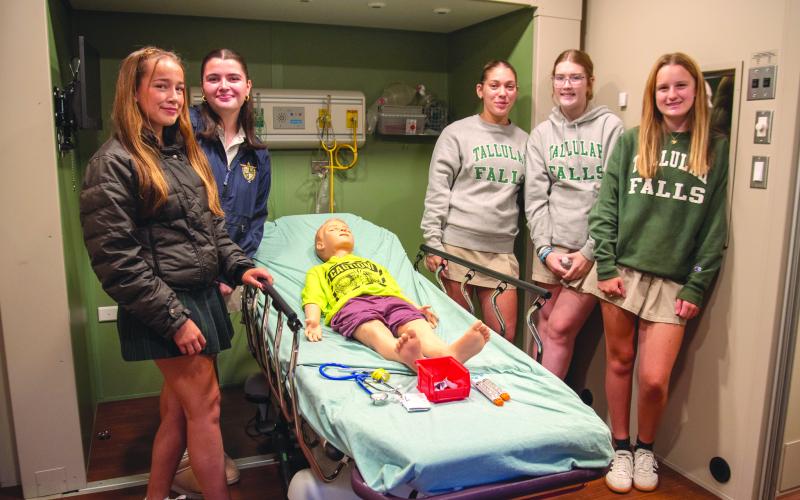 Submitted Photo. TFS juniors Haylen McGugan of Clarkesville, Callee Elrod of Clermont, Sophie Smith of Clarkesville, Shelby Whisnant of Toccoa, and Reagan Duff of Clermont practice using an EPIPen in the simulation lab.