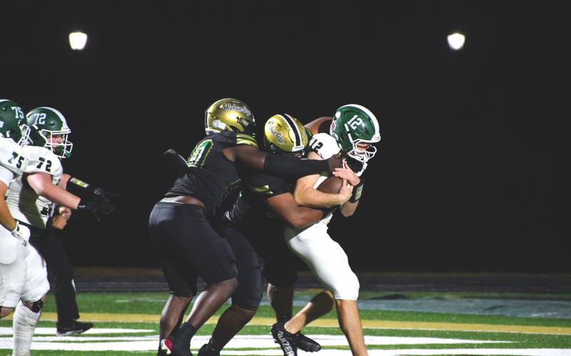 Wesley Branch/The Clayton Tribune. Rabun Gap defensive linemen Isaac Lukuni and Segun Alexander sack Christ School quarterback Jackson Tolbert in the Eagles’ 64-7 home win over the Greenies on Nov. 6. The Rabun Gap defense had three sacks and 10 QB pressures in the game. The Eagles host Charlotte Christian on Nov. 14 in the semifinals.
