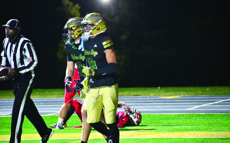 Enoch Autry/The Clayton Tribune. saac Obrokta (8) receives congratulations from Walker Bryson for scoring against the team from Puerto Rico.