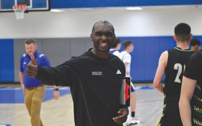 Wesley Branch/The Clayton Tribune. Rabun Gap head basketball coach Devin Liferidge gives a thumbs up following Rabun Gap’s season-opening win over Lanier Christian on Nov. 8 at Banks County High School. The Eagles defeated the Lighting 88-73, securing Liferidge’s first win at RGNS.