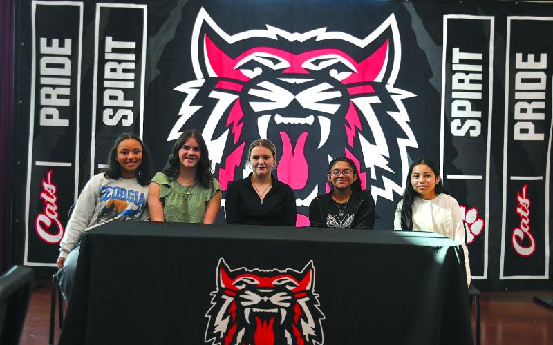 Enoch Autry/The Clayton Tribune. abun County Middle School eighth graders and new REACH scholars Kinley Burtch, Paytn Sharkey, Jasmine Nelson, Neyli Aguilar and Ana Espitia Martinez pose for a photograph at the conclusion of their Nov. 10 signing ceremony.