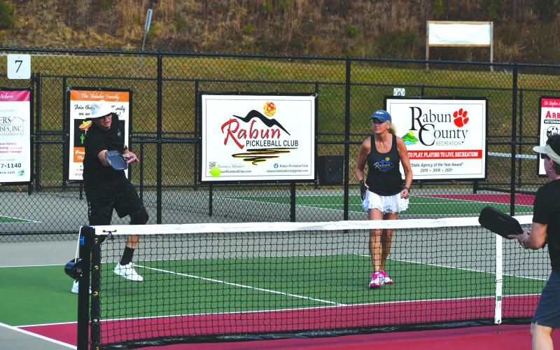Wesley Branch/The Clayton Tribune. Danny Burch (left) and Sonja DeFoor (right) partake in the pickleball demonstration at the dedication of the pickleball courts in Tiger on Nov. 19. Burch said a prayer before the dedication, and DeFoor led the pledge of allegiance.