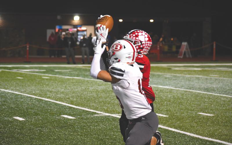 Wesley Branch/The Clayton Tribune. Rabun County senior Reid Giles jumps in front of a pass by Berrien quarterback Cash Perkins for an interception in Rabun County’s 35-0 playoff win over Berrien. Giles finished the game with 212 yards and a rushing touchdown along with the interception.
