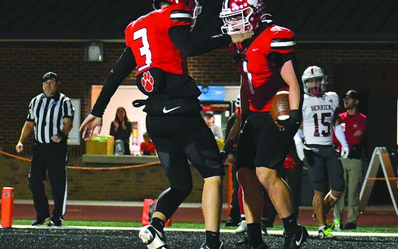Enoch Autry/The Clayton Tribune. Cooper Kowalsky (3) congratulates Lake Evans on his 46-yard TD run.
