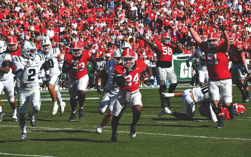 Wesley Branch/The Clayton Tribune. Georgia freshman running back Bo Walker sprints to the end zone for his first career touchdown in Georgia’s 35-3 win over Charlotte on Nov. 22. Walker, who played for Rabun Gap-Nacoochee, scored three rushing touchdowns in the win and ran for 48 yards. UGA plays in-state rival Georgia Tech Friday.