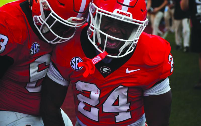 Wesley Branch/The Clayton Tribune. Georgia freshman running back Bo Walker celebrates his first career rushing touchdown with teammate and freshman offensive lineman Dontrell Glover.