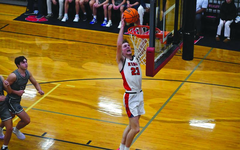 Rabun County senior forward Hayes Free finishes an alley-oop from senior point guard Huey Blalock in Rabun County’s home-opening 83-66 win over White County. Hayes was a preseason All-State selection.