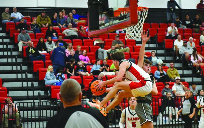 Wesley Branch/The Clayton Tribune. Rabun County senior point guard Huey Blalock navigates through traffic for a tough layup against White County in the Wildcats’ 83-66 home-opening win. Blalock was one of the preseason favorites for player of the year in Georgia.