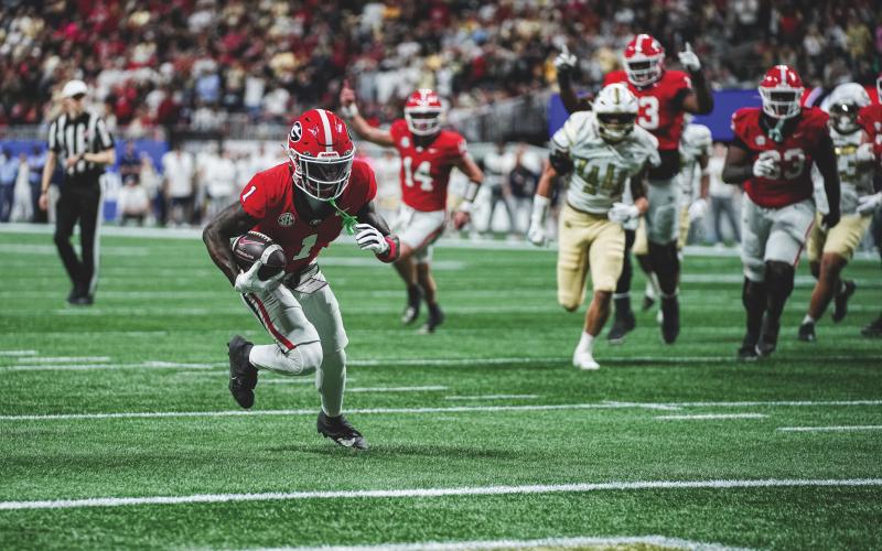 Tony Walsh/UGAAA. Georgia wide receiver Zachariah Branch runs to the end zone for a receiving touchdown in Georgia’s 16-9 win over Georgia Tech on Nov. 28. In the background is former Rabun County and current Georgia quarterback Gunner Stockton. Stockton and Branch connected for the only TD scored in the game.