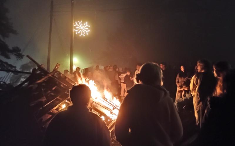 Megan Horn/The Clayton Tribune. Tallulah Falls community members and students at Tallulah Falls School kicked off the holiday season with its annual Town Christmas Party on Friday, Dec. 5. Unique to Tallulah Falls was a giant bonfire that lit up the night sky and warmed eventgoers on a chilly evening.