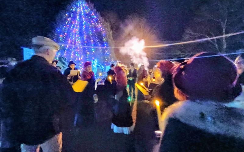 Megan Horn/The Clayton Tribune. The musical group Voices of Truth leads participants at last weekend’s inaugural “Dickens in Dillard” Festival in caroling around the Dillard City Hall Christmas tree.