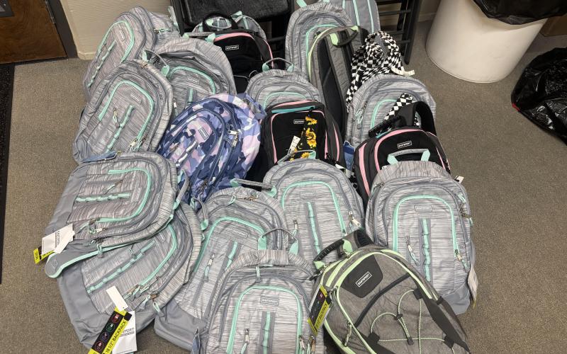 Submitted photo. Carpe Diem Rotary Impact Club members stuffed 75 backpacks full of school supplies for migrant students as part of the year’s many service projects.