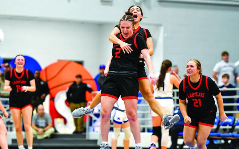 File/Wade Cheek/The Clayton Tribune. Rabun County’s Adelyn Thompson celebrates with Addy Beth Owens after knocking down the game-winning shot against Armuchee High School in the first round of the state playoffs last season. The Lady Wildcats advanced to the Elite Eight for the 10th time in history.
