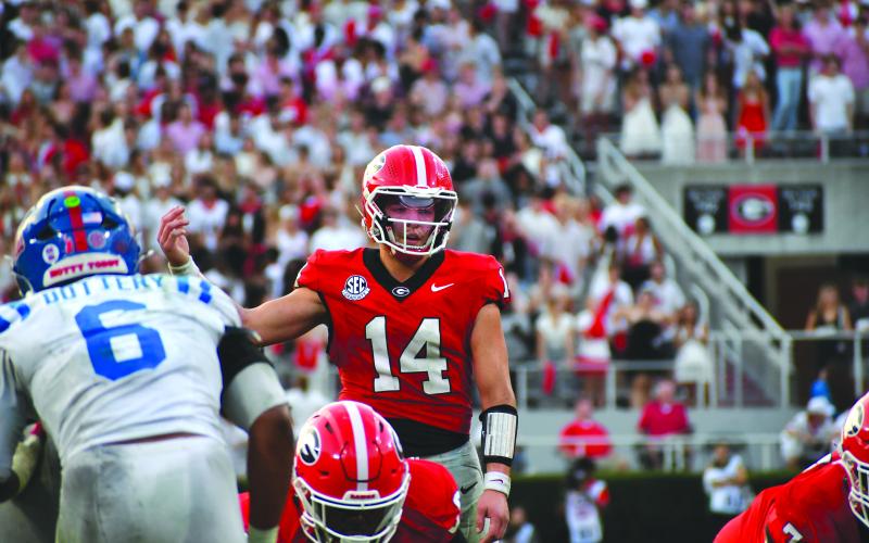 Wesley Branch/The Clayton Tribune. Former Rabun County and current UGA quarterback Gunner Stockton prepares to take a snap in Georgia’s 43-35 win over Ole Miss on Oct. 18. Stockton threw for 289 yards and four touchdowns, while running for 59 yards and a score in the win.  Ole Miss now will face UGA in the playoffs on New Year’s Day.