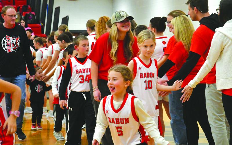 Enoch Autry/The Clayton Tribune. Recreation department players of various ages got to walk around the floor of the gym in a packed gym between the RCHS basketball games.