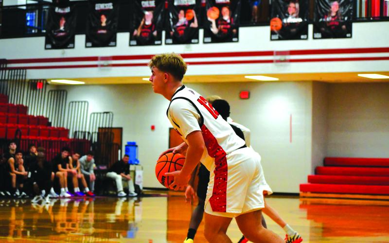 Wesley Branch/The Clayton Tribune. Rabun County junior Reed Burrell surveys the court in Rabun County’s 64-59 win over Rabun Gap on Dec. 19. Burrell led the Wildcats in scoring with 21 points in the win, and made the go-ahead basket with 1:02 remaining.