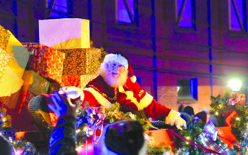 Enoch Autry/The Clayton Tribune. Santa Claus waves to the large crowd at the Clayton Christmas Parade on Dec. 6 on Main Street.