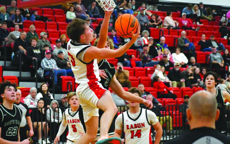 Wesley Branch/The Clayton Tribune. Rabun County senior point guard Huey Blalock fights through contact from North Hall defenders for a layup in Rabun County’s 92-68 win over North Hall on Nov. 25.