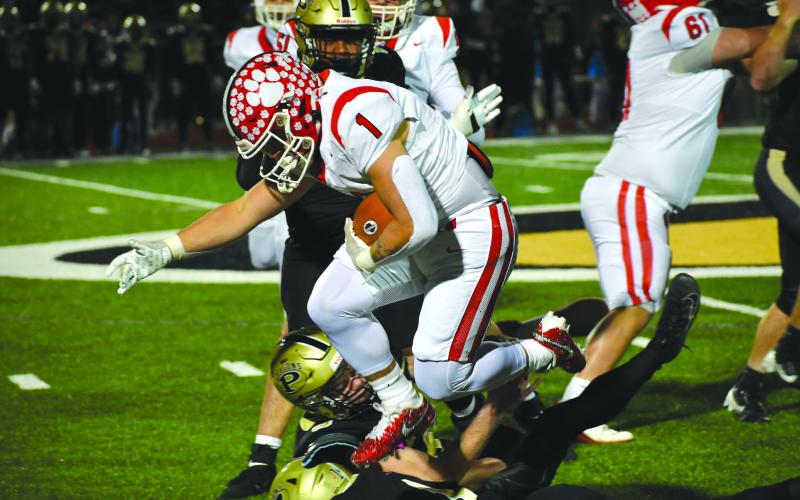 Wesley Branch/The Clayton Tribune. Rabun County senior running back Lake Evans leaps over Pepperell defenders for extra yardage in the Wildcats’ state quarterfinal game versus the Dragons. Evans, a first team all region player, posted 34 yards on five carries in the 34-0 loss.