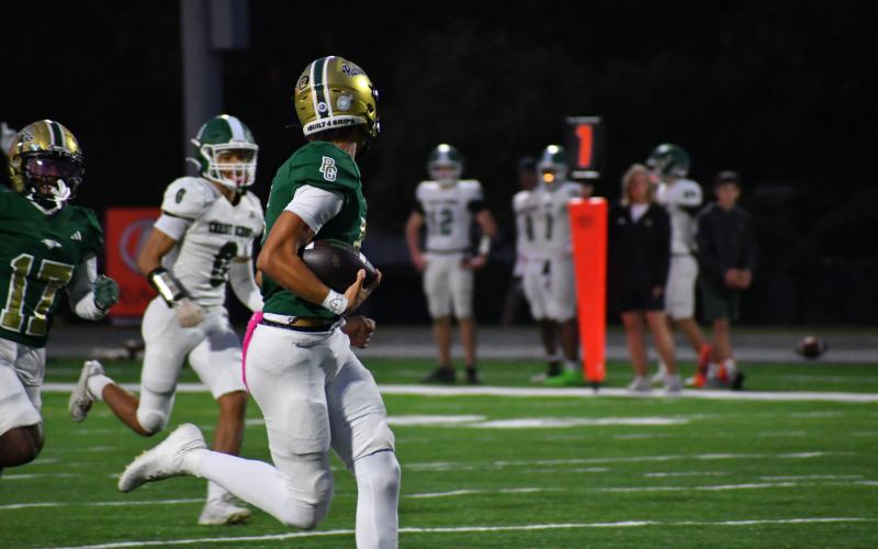 Wesley Branch/The Clayton Tribune. Rabun Gap quarterback Gavin Owens runs into the end zone for a rushing touchdown in Rabun Gap's 42-0 win over Christ School on Oct. 17. Owens officially signed with Memphis University last Wednesday, Dec. 3.