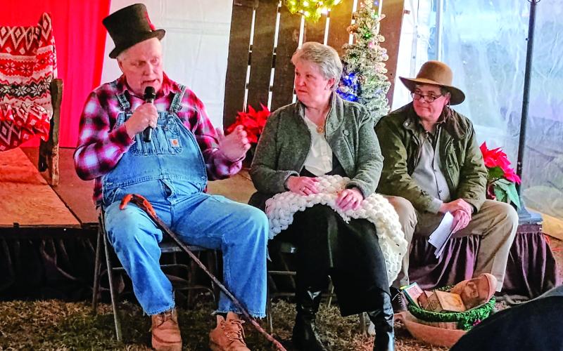 Megan Horn/The Clayton Tribune. The “Dickens in Dillard” festival featured storytelling by the Dillard family. Pictured are Eddie Dillard, Helen Gillespie and John Dillard. Gillespie even made cookies from the original Dillard family recipe.