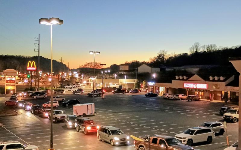 Megan Horn/The Clayton Tribune. Vehicles line up all the way around the Food Bank parking lot to receive gifts for kids during the gift drive on Tuesday. Volunteers handed out gifts to kids of all ages in the community.
