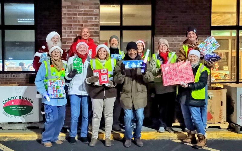Megan Horn/The Clayton Tribune. Volunteers at the Dec. 16 Food Bank of Northeast Georgia toy drive include James Brim, director of the Food Bank of Northeast Georgia Mountain Branch; Donna Long; Herman Bunn; Renee Ramsay; Stan Vik; Janet Vik; Cherye Weintraub; Stephen Weintraub; Beth Nelson; Mark Shryock; Brenda Cook; and even Santa Claus himself!