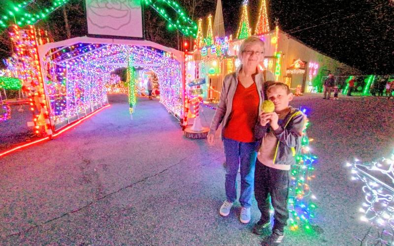 Megan Horn/The Clayton Tribune. Helen Godwin, left, and Reece Ferguson, 7, enjoy the elaborate Christmas Village of Lights display in Tiger last weekend. The holiday event continues this weekend and support the local nonprofit Fight Abuse In The Home (F.A.I.T.H.).
