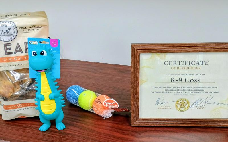 Megan Horn/The Clayton Tribune.  K-9 Coss retired from the Rabun County Sheriff’s Office and received a toy, treats and a Certificate of Retirement during a ceremony Dec. 10. The certificate was presented to K-9 Coss for his dedicated service, unwavering loyalty, and exceptional commitment.