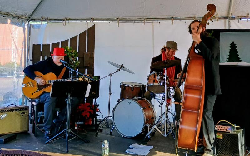 Megan Horn/The Clayton Tribune. Mueller, Webb &amp; Wilson Band play live music in Cratchit’s Corner at the inaugural “Dickens in Dillard" Festival last Saturday.