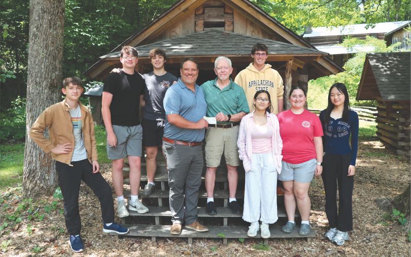 Rabun Youth Educational Support, Inc., (RabunYES), donated over $10,000 to the Summer Project Foxfire youth program. Tom Buckridge, RabunYES treasurer, had the chance to speak to program students and present the check to Foxfire Executive Director Todd Faircloth. The donation was made in honor of Buckridge’s late wife, Jean, whose passion was to help young people. Pictured are Jaden Shurtliff, left, Caden Watt, Sean Flaherty, Faircloth, Buckridge, Wyatt Arbitter, Tara Shyrock, Abby Streetman and Sunny Lin.