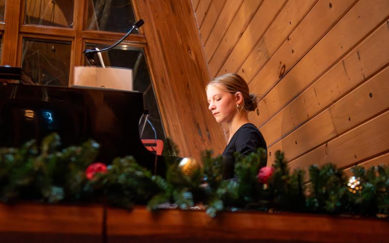 Submitted photo. Rachel McDowell plays a Christmas carol on the piano in the Norwood Key Taylor Chapel on the main TFS campus.