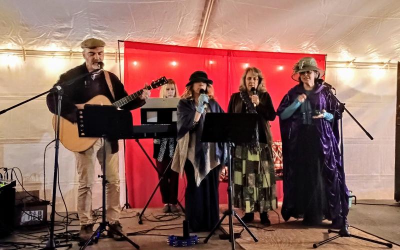 Megan Horn/The Clayton Tribune. The Voices of Truth group sings music about Jesus in Cratchit’s Corner at the inaugural “Dickens in Dillard” Christmas Festival last Saturday.