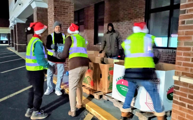 Megan Horn/The Clayton Tribune. Volunteers at the Food Bank of Northeast Georgia helped spread Christmas cheer on Tuesday, Dec. 16, as they passed out gifts to kids of all ages during a toy drive the week before Christmas.