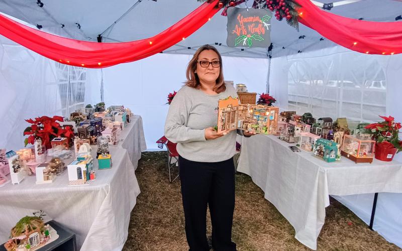 Megan Horn/The Clayton Tribune. Yacenia Rengifo features her arts and crafts during the inaugural “Dickens in Dillard” festival Dec. 13.