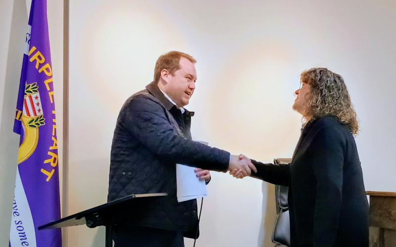 Megan Horn/The Clayton Tribune.  Beth Pence was voted-in by Sky Valley residents as one of three new council members representing the city. She shakes hands with City Attorney Douglas Kidd during the Jan. 6 organizational and special called Sky Valley council meeting. Pence was also selected by fellow council members to serve as Council President.