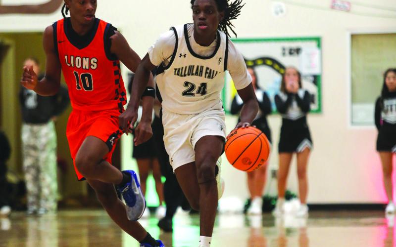 Photo courtesy Audrey Borchers. Brian Neely pushes the ball up the court in TFS’s 75-33 road win over Riverside Military Academy on Jan. 13. The Indians are ranked third.