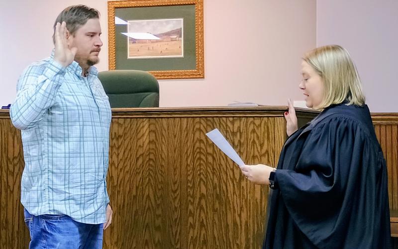 Megan Horn/The Clayton Tribune. Incoming Council Member Channing Watts takes his Oath of Office before Rabun County Probate Judge Savannah Dixon Jan. 5 after being elected as the Clayton council member for Post 1.