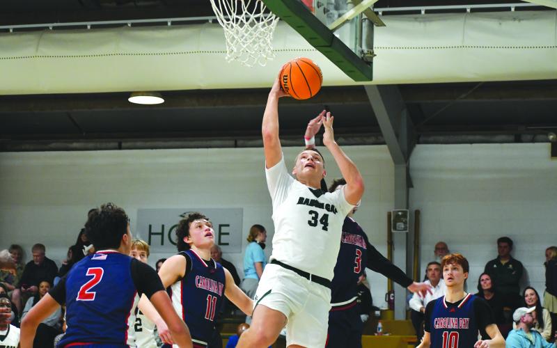 Wesley Branch/The Clayton Tribune. Rabun Gap sophomore Grayson Clary goes in for a layup in Rabun Gap’s 66-49 win over Carolina Day on Jan. 8. Clary, who is a highly recruited quarterback for the Rabun Gap football team, joined the boys basketball team in December.
