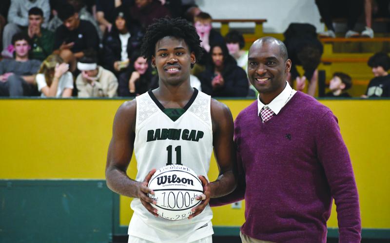 Wesley Branch/The Clayton Tribune. Rabun Gap senior RJ Lacossade poses with Rabun Gap boys head basketball coach Devin Liferidge during a recognition for Lacossade scoring 1,000 career points at halftime of Rabun Gap’s 83-60 win over Winston Salem Christian on Jan. 9. Lacossade is averaging 22 points and 10 rebounds for the Eagles this season.