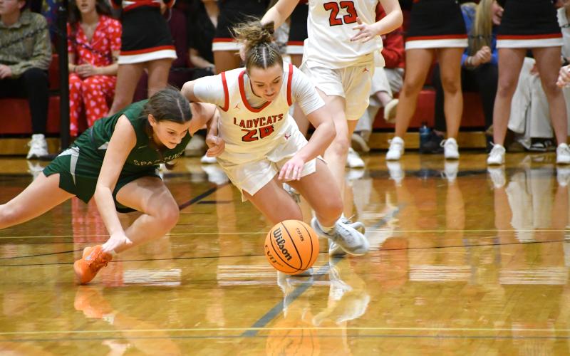 Wesley Branch/The Clayton Tribune. Rabun County’s Millie Southards and Athens Academy’s Millie Pugmire fight for a loose ball on the final possession of Rabun County’s 51-48 win over Athens Academy on Jan 13. Southards knocked the ball free on the last possession, sealing the win for the Lady Wildcats.