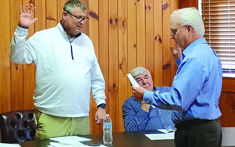Megan Horn/The Clayton Tribune. Incumbent City of Dillard Mayor Claude Dillard, left, is sworn-in for another term in office by City Attorney Jay Doss to start the Tuesday, Jan. 13, meeting. Doss also was re-appointed as the city’s attorney.