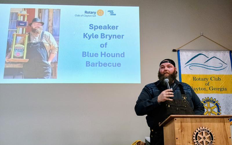 Megan Horn/The Clayton Tribune. Kyle Bryner, owner of Blue Hound Barbecue in Dillard, speaks to Rotary Club of Clayton members about his passion for cooking during the Jan. 8 club meeting.